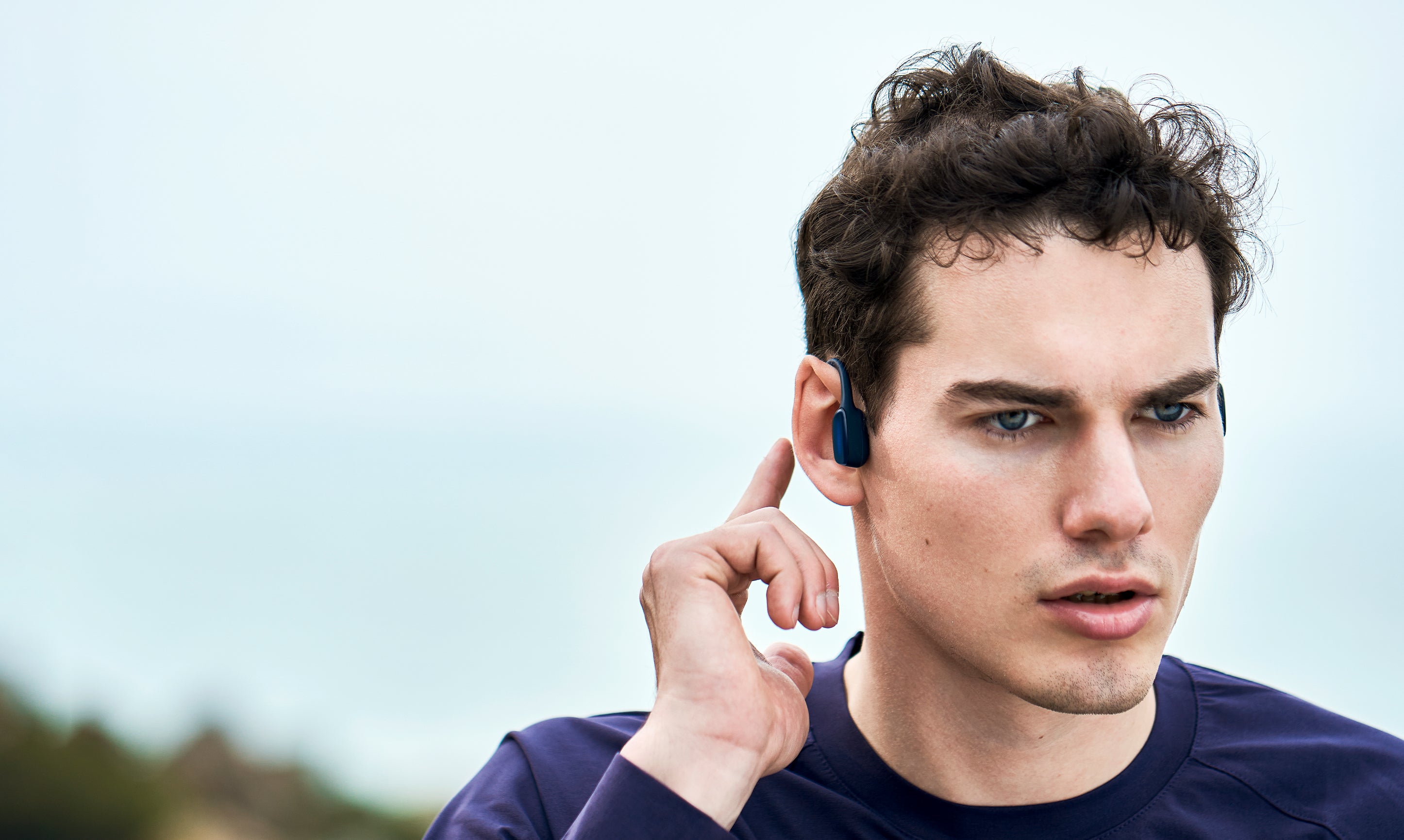 man-wears-HaptiFit-Terra-open-ear-headphone